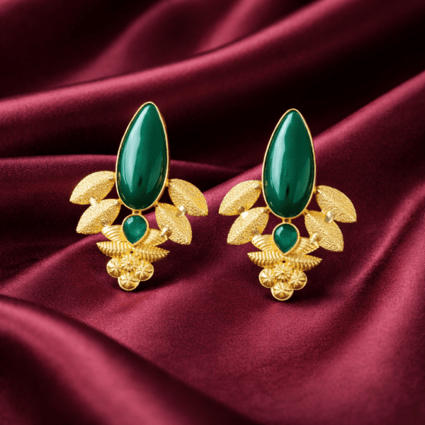 Elegant gold earrings on silk fabric