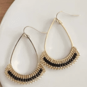 Elegant gold earrings on soft fabric