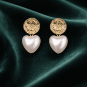 Elegant gold earrings on velvet fabric