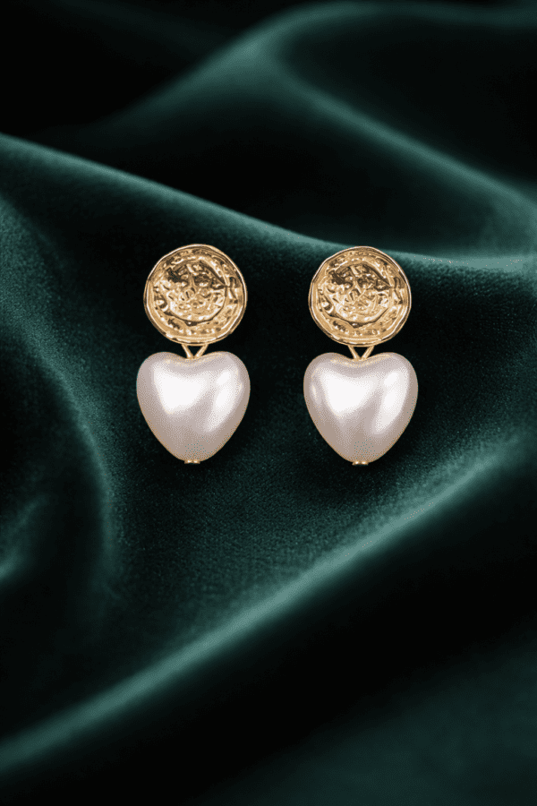 Elegant gold earrings on velvet fabric