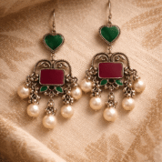 Ornate silver earrings on fabric